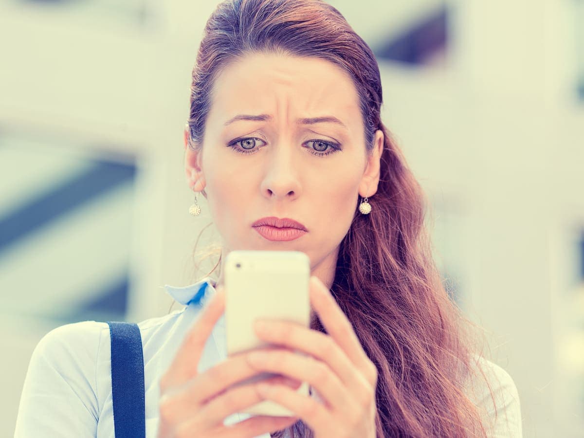 A parent reading a notification on their phone